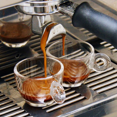 Two shots of espresso being pulled from an espressomachine.